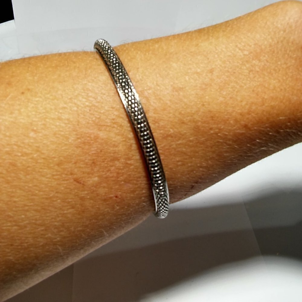 Women`s silver tone mesh bangle bracelet.